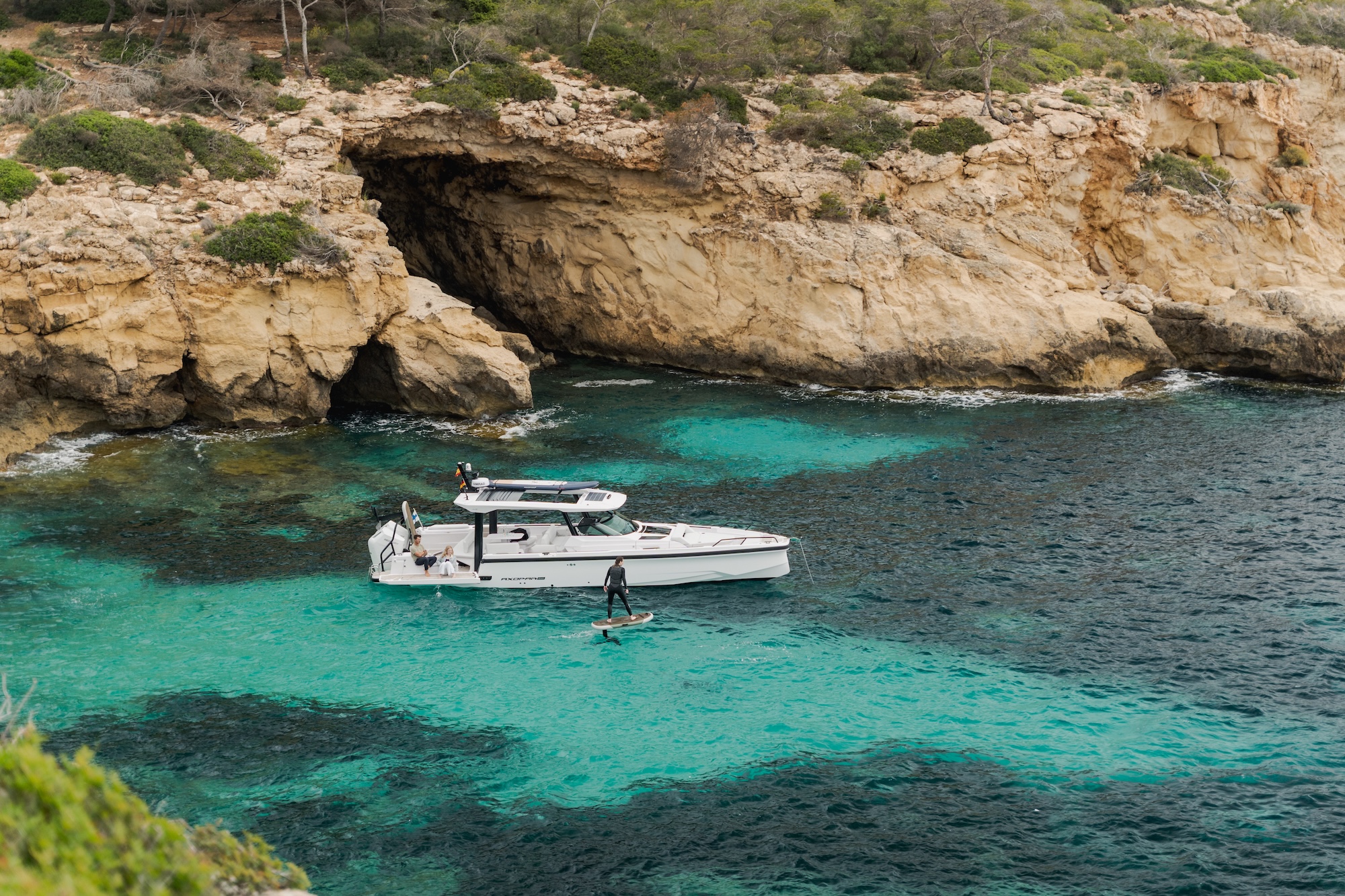 Tender alongside a yacht in clear coastal water