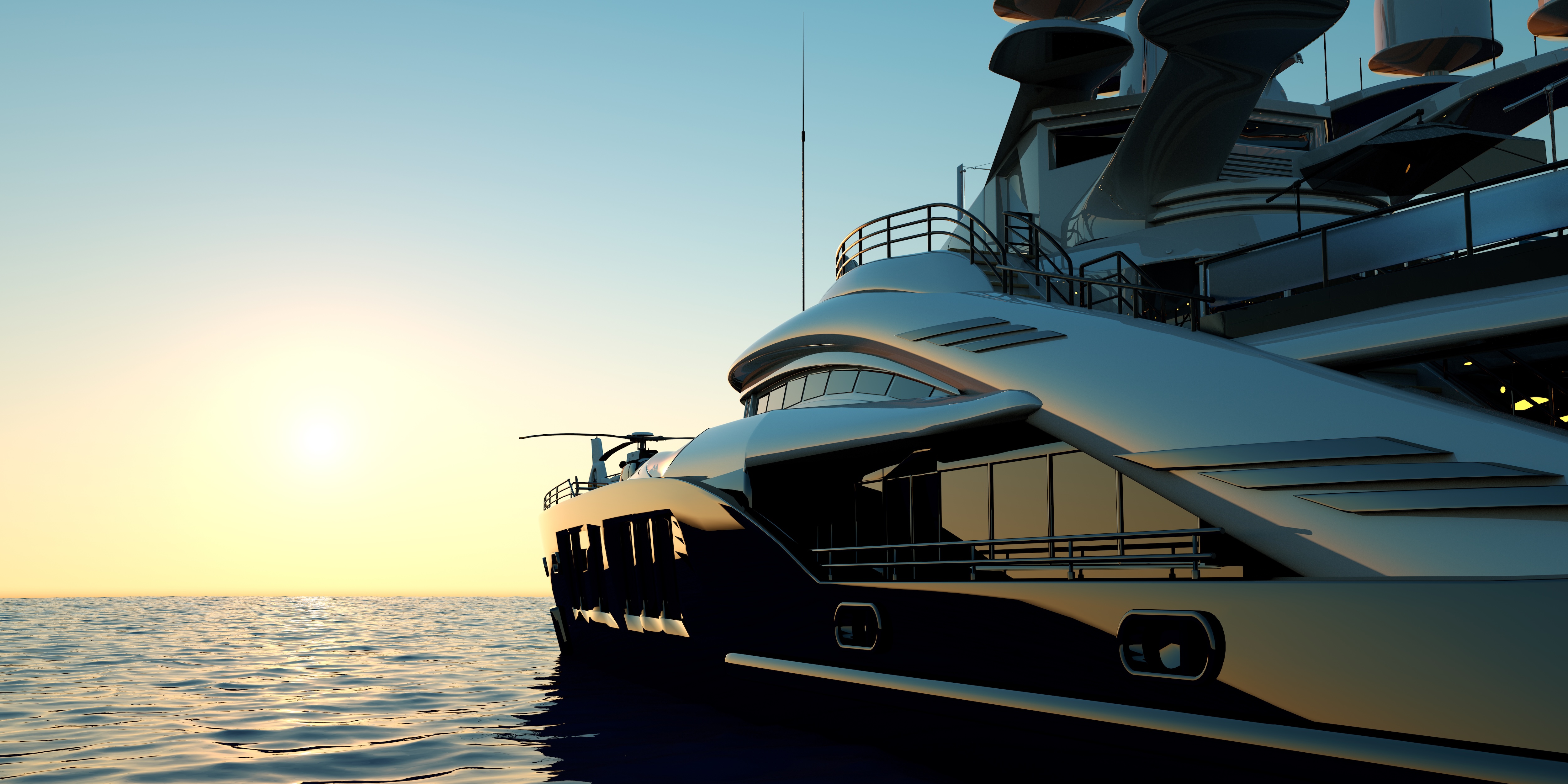 Superyacht at anchor along a rocky coastline